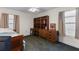 Comfortable bedroom features neutral walls, carpet flooring, and a built-in wooden desk and shelving unit at 2559 Wood Oak Dr, Sarasota, FL 34232