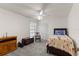 Charming bedroom with a floral quilt, ceiling fan, and neutral decor at 2559 Wood Oak Dr, Sarasota, FL 34232