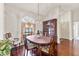 Elegant dining room featuring hardwood floors, a decorative light fixture, and large window at 2559 Wood Oak Dr, Sarasota, FL 34232