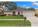 Charming single-story home featuring a well-manicured lawn and attached two-car garage at 2559 Wood Oak Dr, Sarasota, FL 34232