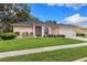 Charming single-story home featuring a well-manicured lawn and attached two-car garage at 2559 Wood Oak Dr, Sarasota, FL 34232