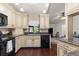 Bright kitchen with custom cabinets, granite countertops, and modern black appliances at 2559 Wood Oak Dr, Sarasota, FL 34232