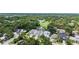 An elevated view of a neutral-colored home with a two-car garage surrounded by lush landscaping at 2590 Floyd St, Sarasota, FL 34239