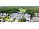 An aerial view shows a white two-story home with a well-manicured lawn and an attached two-car garage at 2590 Floyd St, Sarasota, FL 34239