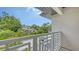 Balcony view shows a geometric railing with neighborhood views, showcasing a blend of modern design and suburban charm at 2590 Floyd St, Sarasota, FL 34239