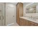 Modern bathroom with a sleek vanity, illuminated mirror, and a glass-enclosed shower at 2590 Floyd St, Sarasota, FL 34239