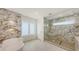 Luxurious bathroom with marble accents, a soaking tub, and a glass-enclosed shower at 2590 Floyd St, Sarasota, FL 34239