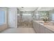 Contemporary bathroom featuring a glass-enclosed shower and double sink vanity at 2590 Floyd St, Sarasota, FL 34239