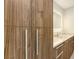 Close up view of wood cabinet with quartz countertop and a mirror with inset lighting at 2590 Floyd St, Sarasota, FL 34239