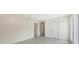 A spacious bedroom with a neutral color palette and multiple doors at 2590 Floyd St, Sarasota, FL 34239
