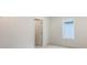 Minimalist bedroom with white walls and a window, providing a clean and bright space at 2590 Floyd St, Sarasota, FL 34239