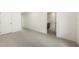Large bedroom area with tiled floor and bright lighting, doorway to en suite bathroom at 2590 Floyd St, Sarasota, FL 34239