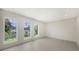 Sunlit bedroom with large windows and modern tile flooring, creating a comfortable atmosphere at 2590 Floyd St, Sarasota, FL 34239