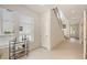 A bright entryway with gray tile floors and view of the stairway at 2590 Floyd St, Sarasota, FL 34239