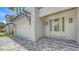 Exterior shot of the home showing the garage, front door, and brick paver driveway at 2590 Floyd St, Sarasota, FL 34239