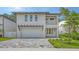 Stunning two-story modern home with a gray brick driveway and pergola over the garage at 2590 Floyd St, Sarasota, FL 34239