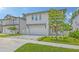 Beautiful two-story home with a gray driveway, a pergola over the garage, and manicured landscaping at 2590 Floyd St, Sarasota, FL 34239