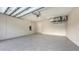 Spacious garage featuring epoxy flooring, ample lighting, and overhead storage, offering a clean and functional space at 2590 Floyd St, Sarasota, FL 34239
