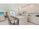 Modern kitchen featuring a marble countertop, bar stool seating and a view into the living room at 2590 Floyd St, Sarasota, FL 34239
