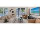 Modern living room featuring neutral decor, a large sliding glass door to the pool, and plenty of sunlight at 2590 Floyd St, Sarasota, FL 34239