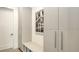 Mudroom features custom built-ins for storage and organization, and modern art at 2590 Floyd St, Sarasota, FL 34239