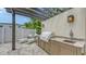 Outdoor kitchen with granite countertops, a built-in grill, and lounge chairs perfect for outdoor entertaining at 2590 Floyd St, Sarasota, FL 34239
