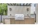Outdoor kitchen with granite countertops, a built-in grill, and a sink perfect for outdoor entertaining at 2590 Floyd St, Sarasota, FL 34239