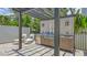 Outdoor kitchen with grill, fridge, sink, and counterspace, perfect for entertaining and poolside relaxation at 2590 Floyd St, Sarasota, FL 34239