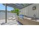 This outdoor kitchen features a stainless steel grill, countertop, sink, and stylish lounge chairs at 2590 Floyd St, Sarasota, FL 34239
