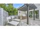 Outdoor kitchen with stainless steel grill, fridge, and lounge seating at 2590 Floyd St, Sarasota, FL 34239
