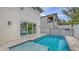 Backyard swimming pool with spa, patio, and sliding glass doors at 2590 Floyd St, Sarasota, FL 34239