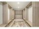 Organized walk-in closet with custom shelves, drawers, and seating offering a luxurious dressing experience at 2590 Floyd St, Sarasota, FL 34239