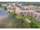 Scenic aerial view of condo complex with lake, pool, and lush landscaping at 3635 Lake Bayshore Dr # J-410, Bradenton, FL 34205