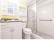 Bathroom with a white vanity, toilet, and a glass-enclosed shower with tile surround at 3635 Lake Bayshore Dr # J-410, Bradenton, FL 34205