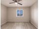 This bedroom features hardwood floors and a ceiling fan at 3635 Lake Bayshore Dr # J-410, Bradenton, FL 34205