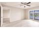 Bedroom with a ceiling fan and sliding doors to a balcony overlooking a lake at 3635 Lake Bayshore Dr # J-410, Bradenton, FL 34205