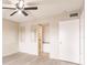 Bedroom with two large mirrors, a ceiling fan, and an entrance to the bathroom at 3635 Lake Bayshore Dr # J-410, Bradenton, FL 34205