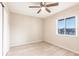 This bedroom features hardwood floors, a ceiling fan, and a window at 3635 Lake Bayshore Dr # J-410, Bradenton, FL 34205