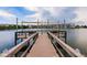 Waterfront dock featuring cozy seating and awning, offering a tranquil retreat at 3635 Lake Bayshore Dr # J-410, Bradenton, FL 34205