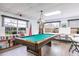 Bright game room featuring a billiard table, large windows and plenty of natural light at 3635 Lake Bayshore Dr # J-410, Bradenton, FL 34205