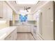 A bright and airy kitchen with ample white cabinetry, luxury vinyl plank flooring and modern appliances at 3635 Lake Bayshore Dr # J-410, Bradenton, FL 34205