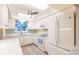 Well-lit kitchen featuring white appliances and cabinets, solid surface countertops, and luxury vinyl plank flooring at 3635 Lake Bayshore Dr # J-410, Bradenton, FL 34205