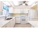 Kitchen featuring white cabinets, stainless steel appliances, and luxury vinyl plank flooring at 3635 Lake Bayshore Dr # J-410, Bradenton, FL 34205