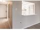 Hallway view of the kitchen featuring white cabinets, light countertops, and luxury vinyl plank flooring at 3635 Lake Bayshore Dr # J-410, Bradenton, FL 34205