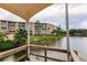 Water view from the dock featuring lakeside building and lush green landscaping at 3635 Lake Bayshore Dr # J-410, Bradenton, FL 34205