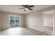Bright main bedroom with luxury vinyl plank flooring, a ceiling fan and a water view at 3635 Lake Bayshore Dr # J-410, Bradenton, FL 34205