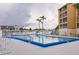 Relaxing community pool with ladder and palm trees, great for leisure and recreation at 3635 Lake Bayshore Dr # J-410, Bradenton, FL 34205