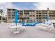 Community pool with lounge chairs and umbrellas, perfect for relaxing by the water at 3635 Lake Bayshore Dr # J-410, Bradenton, FL 34205