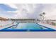 Inviting community pool with clear blue water and a building in the background on a partly cloudy day at 3635 Lake Bayshore Dr # J-410, Bradenton, FL 34205