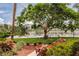 Tranquil view of the lake with shade trees and walking paths at 3635 Lake Bayshore Dr # J-410, Bradenton, FL 34205